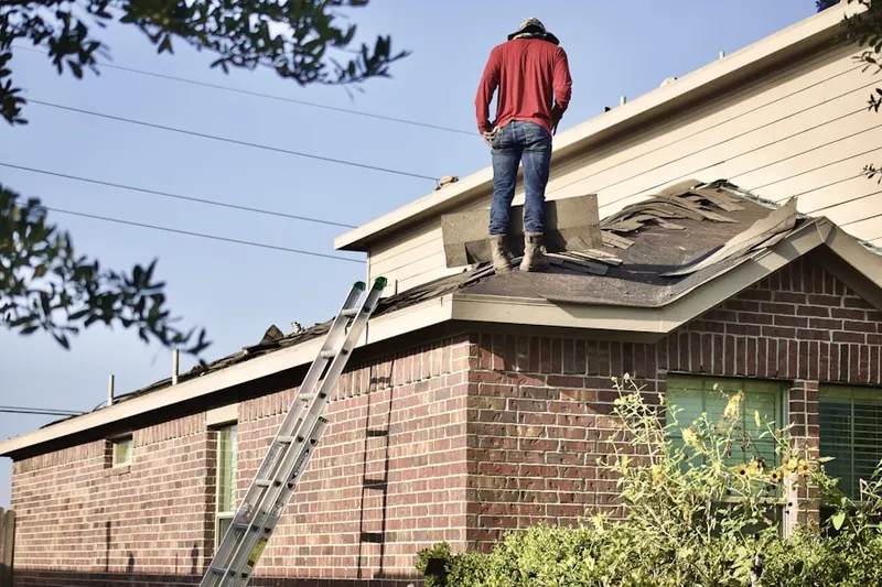 Professional roofer working on a residential roof in Morgan State University